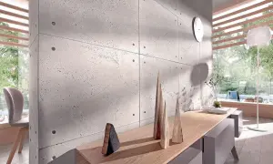 Nowoczesna ściana z betonu architektonicznego, inspiracja jak kłaść beton dekoracyjny na ścianę. Drewniane dekoracje i światło tworzą przytulną atmosferę.