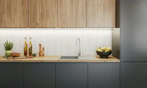 Nowoczesna kuchnia z drewnianymi frontami, szarymi szafkami i białym, jodełkowym backsplash. Zobacz, jak zamontować blat w kuchni.